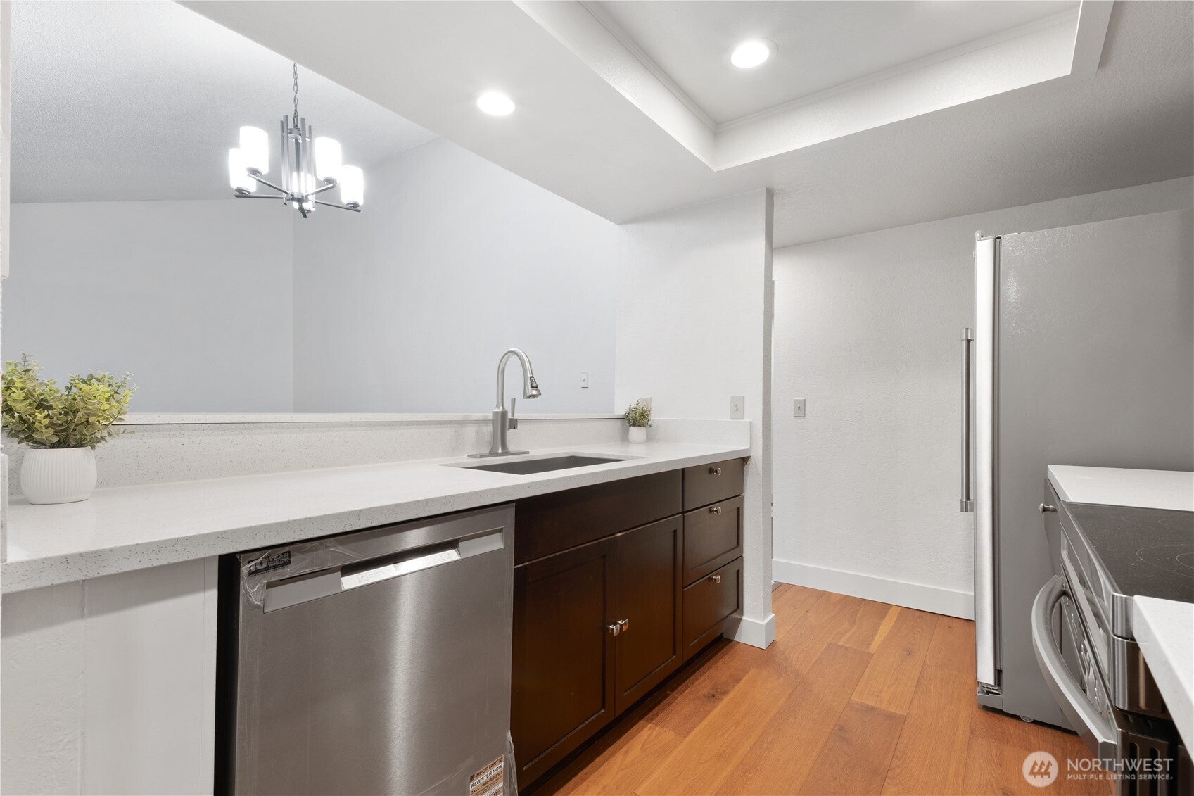 14401 Southeast Petrovitsky Road, Unit B209 Renton, WA 98058 - Photo 8 of 35 a kitchen with a sink and a refrigerator
