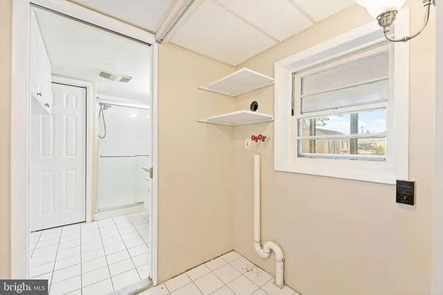 a kitchen with stainless steel appliances granite countertop a refrigerator a stove and a sink with wooden floor