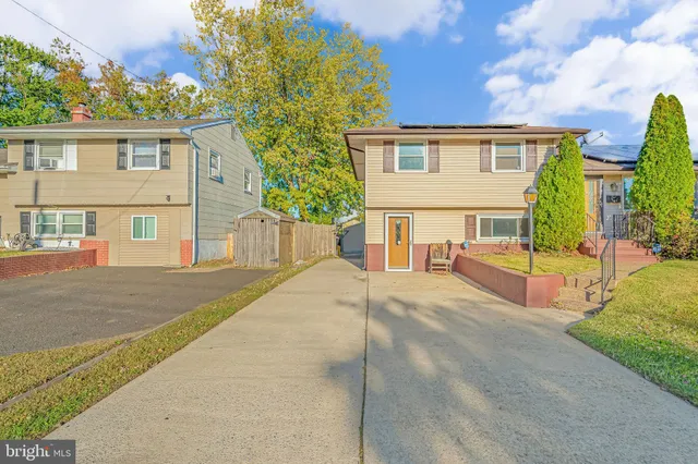 a house view with swimming pool and trees in the background