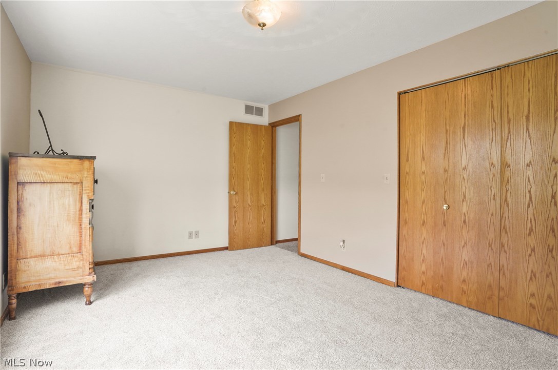 1106 Apple Ridge Road Clinton, OH 44216 - Photo 21 of 27 Unfurnished bedroom with light carpet and a closet