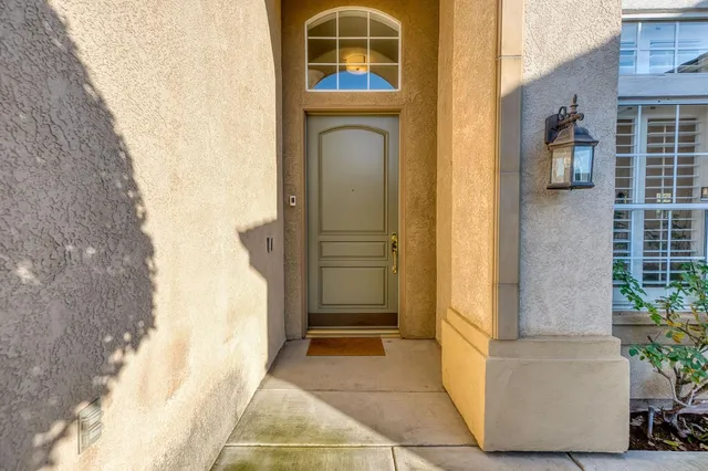 a living room with furniture a fireplace and a chandelier