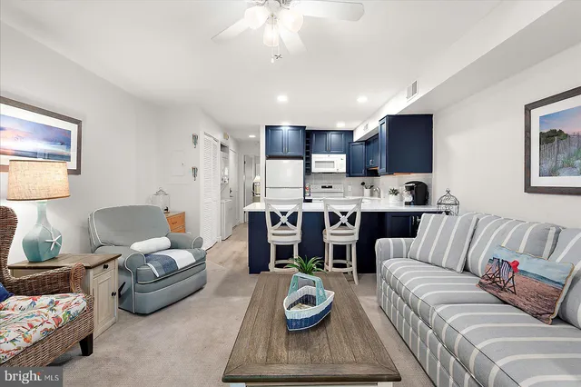 a living room with furniture kitchen and a table