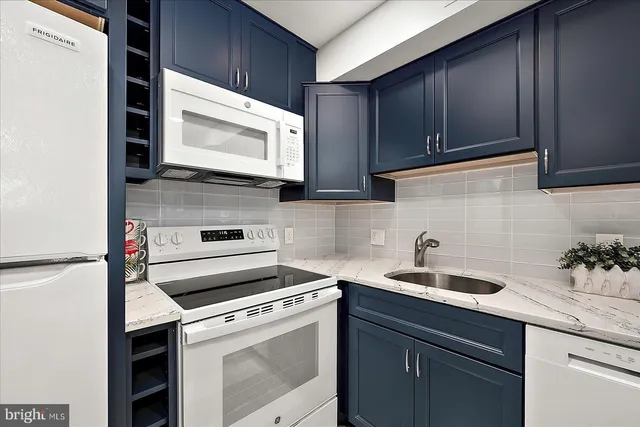 a kitchen with a sink stove and microwave