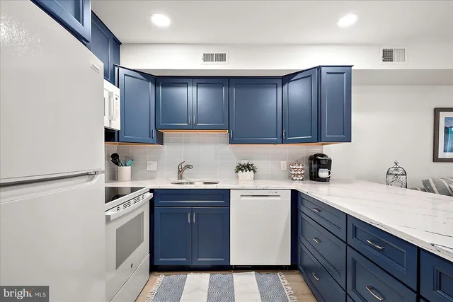 a kitchen with a sink a stove and cabinets