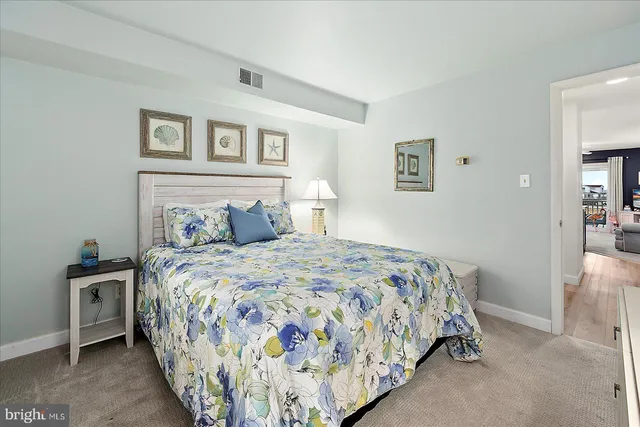 a bedroom with a bed and painting on the wall