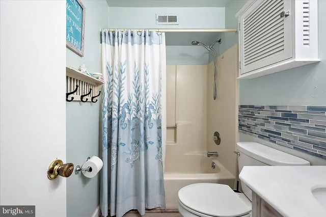 a bathroom with a toilet a sink and shower