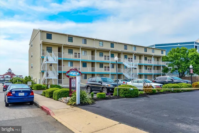 a front view of a house with a garden and plants