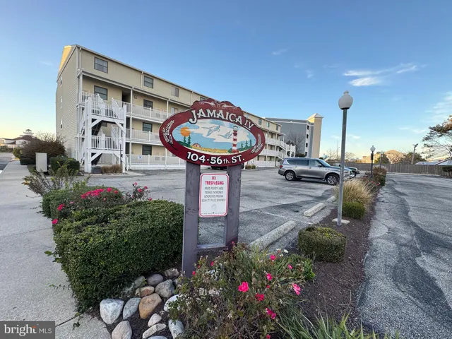 a front view of a house with a yard and fountain