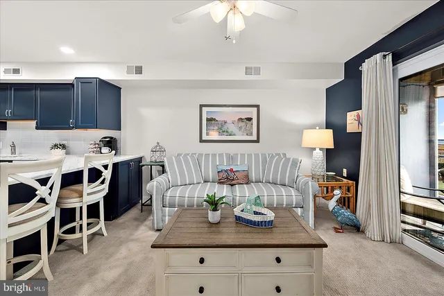 a living room with furniture a flat screen tv and a table