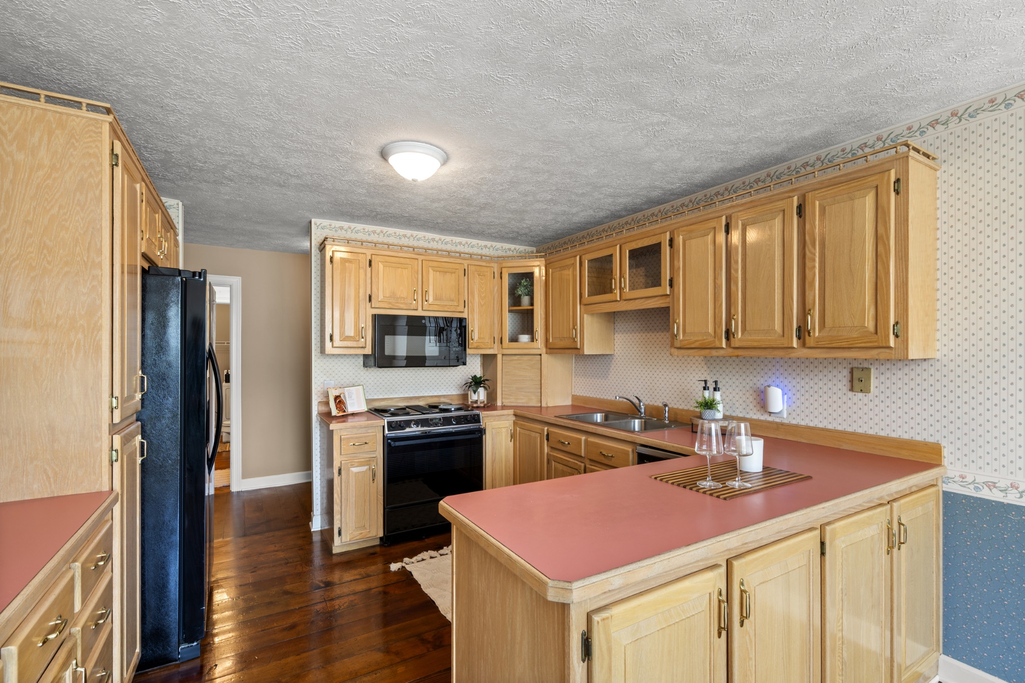 1010 State Highway 48 Dickson, TN 37055 - Photo 16 of 59 a kitchen with a stove a sink dishwasher a refrigerator and cabinets with wooden floor