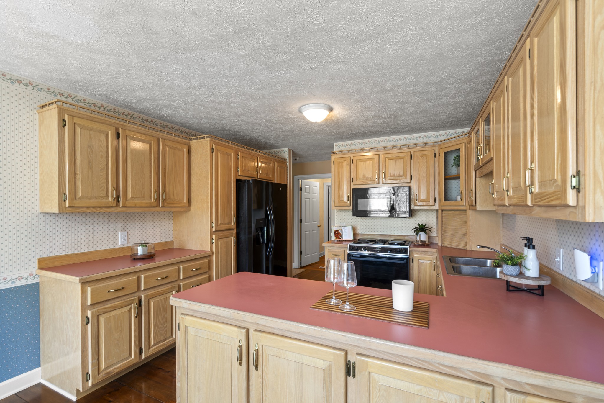 1010 State Highway 48 Dickson, TN 37055 - Photo 17 of 59 a kitchen with kitchen island white cabinets and refrigerator
