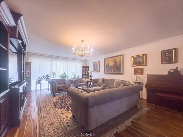 a living room with furniture and a chandelier