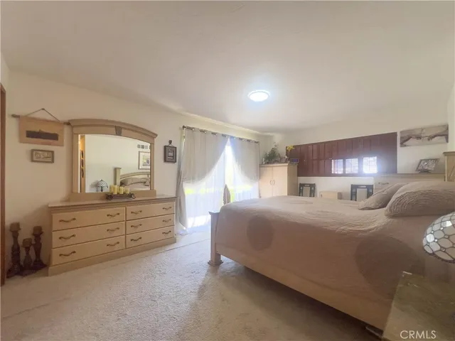 a spacious bedroom with a bed and a table