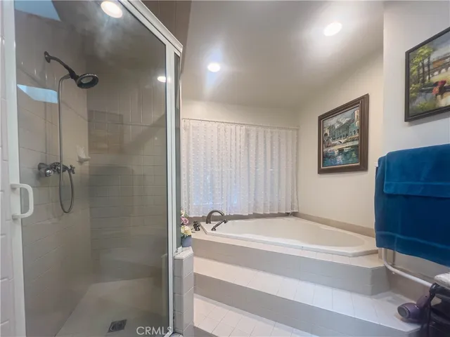 a bathroom with a granite countertop toilet sink and mirror