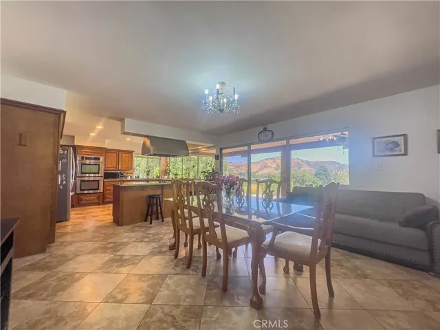 a view of a dining room with furniture and chandelier