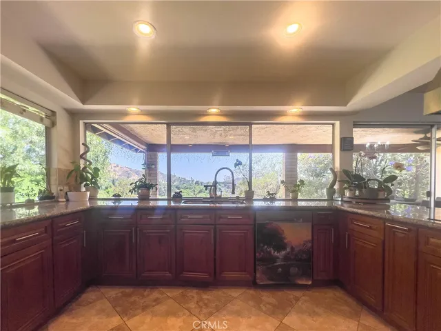 a kitchen with stainless steel appliances granite countertop a refrigerator and a sink