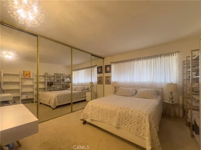 a bedroom with a bed and chair