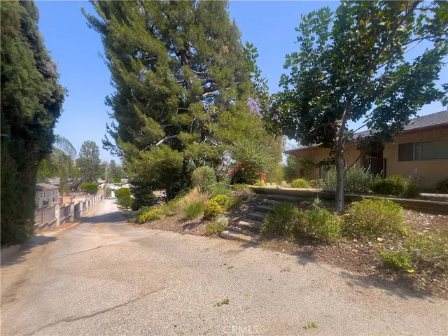 a view of backyard with outdoor seating and wooden fence