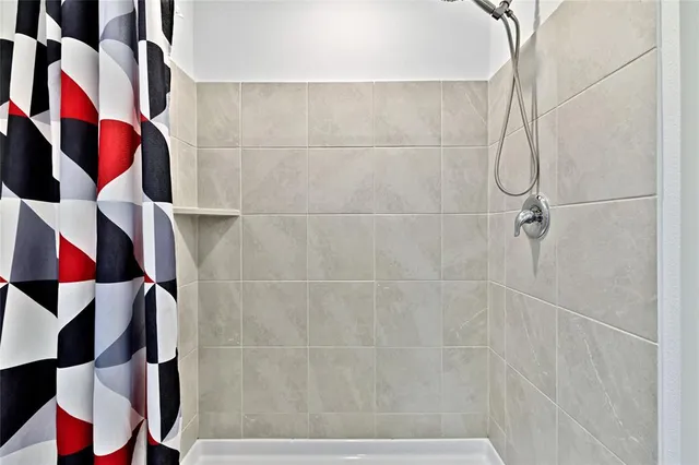 a bathroom with a shower and a sink