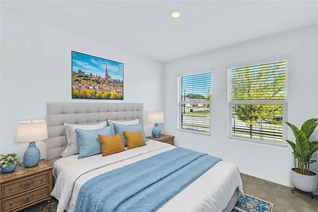 a bedroom with bed and a potted plant