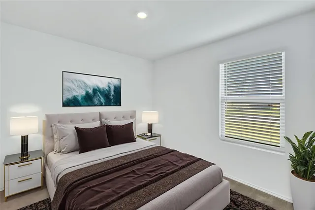 a bedroom with a bed and a potted plant