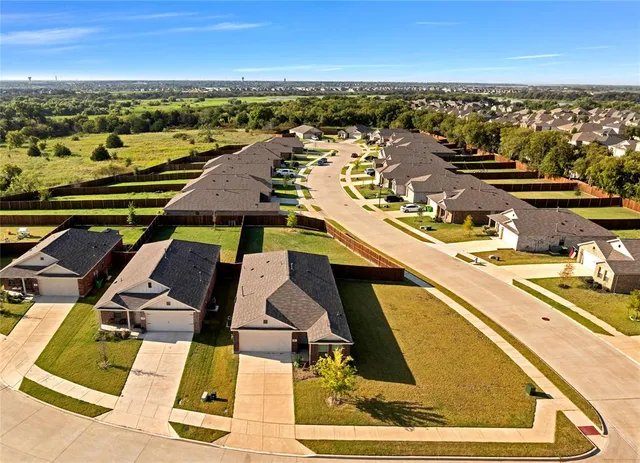 an aerial view of residential houses with outdoor space