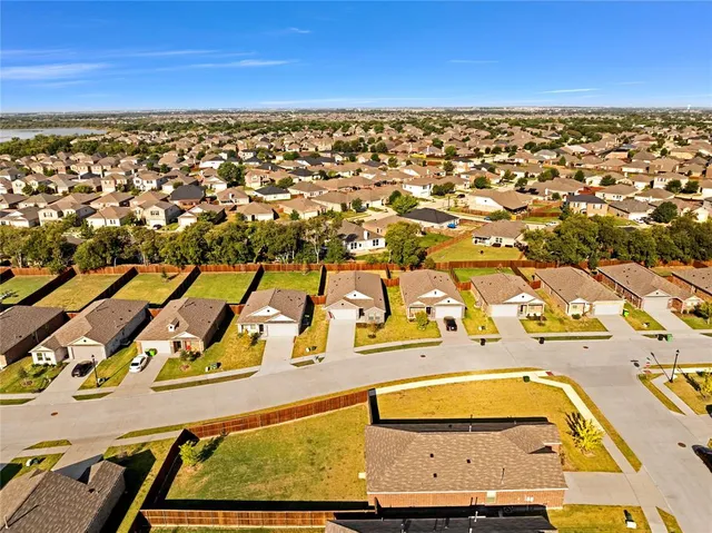 an aerial view of residential houses with outdoor space