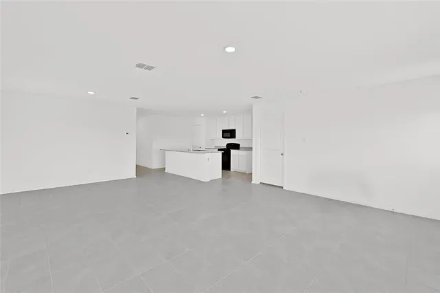 a view of a kitchen with white cabinets