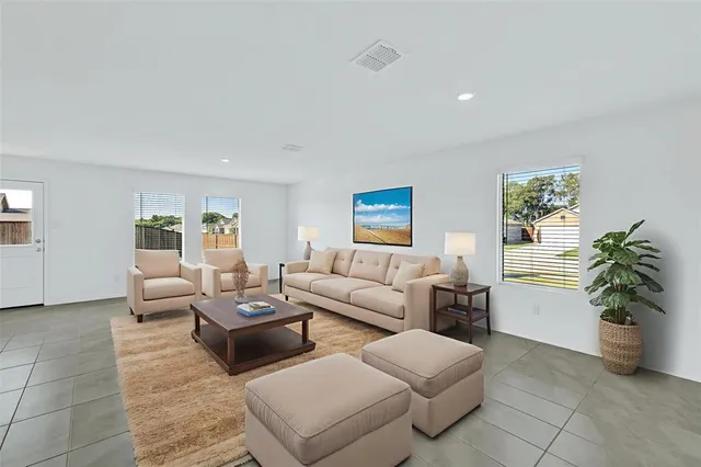 a living room with furniture and a potted plant