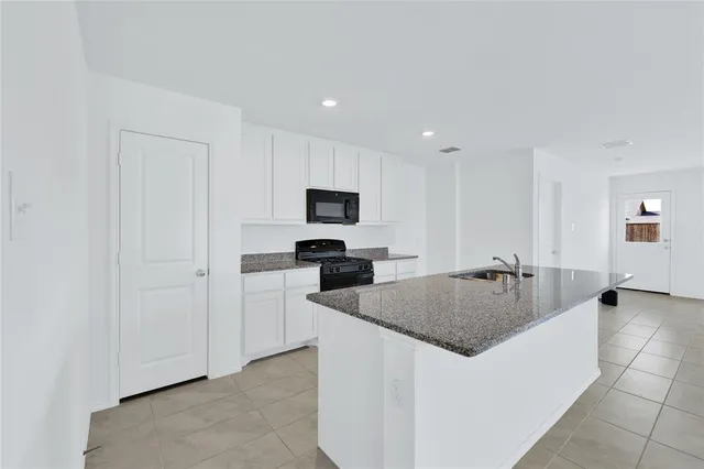 a kitchen with sink refrigerator and microwave