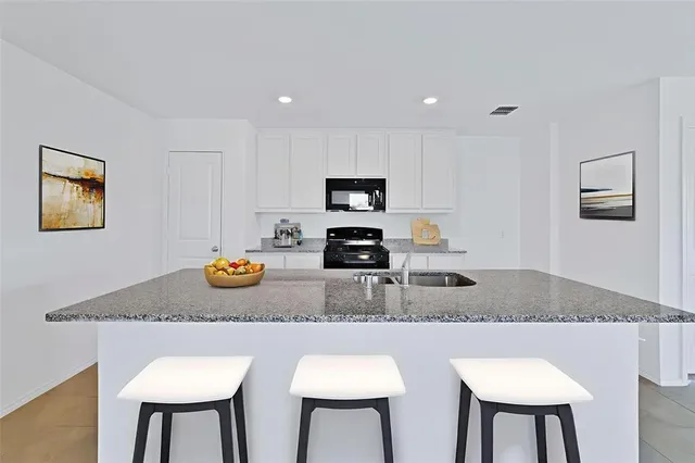 a kitchen with a table chairs and a refrigerator