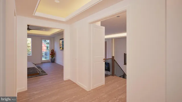 a view of a hallway with wooden floor and a livingroom