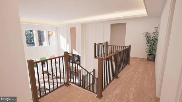 a view of a hallway with wooden floor and stairs