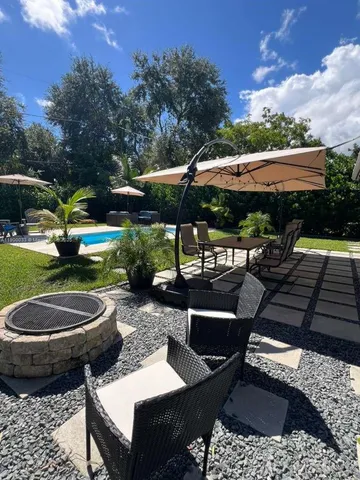 a kitchen with a white cabinets stove and wooden floor