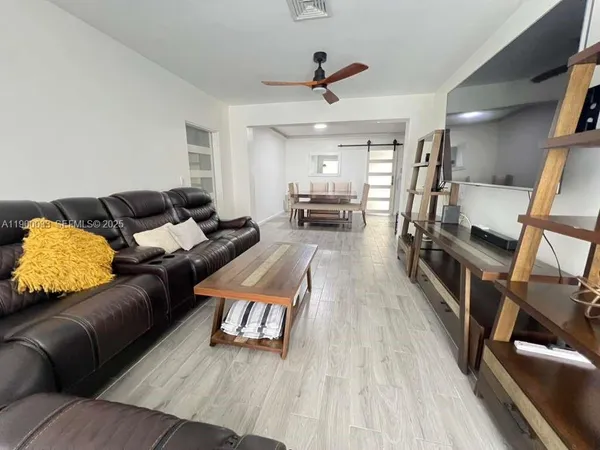 a dining room with furniture and wooden floor