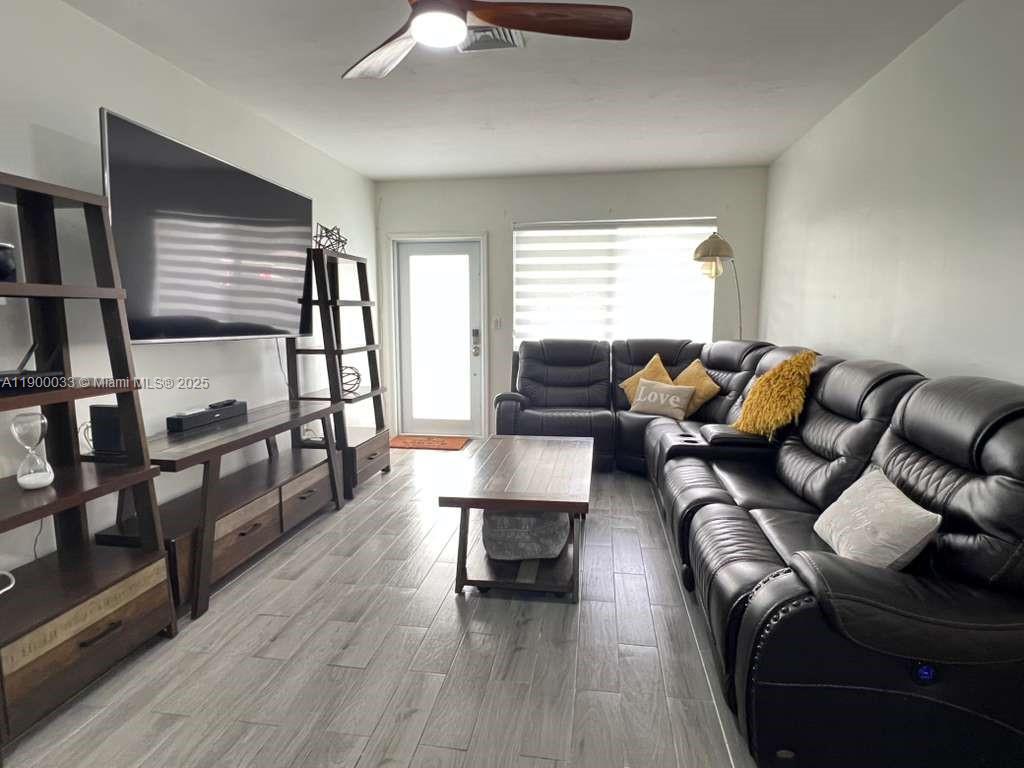 1430 Northeast 149th Street Miami, FL 33161 - Photo 18 of 51 a living room with furniture and a wooden floor