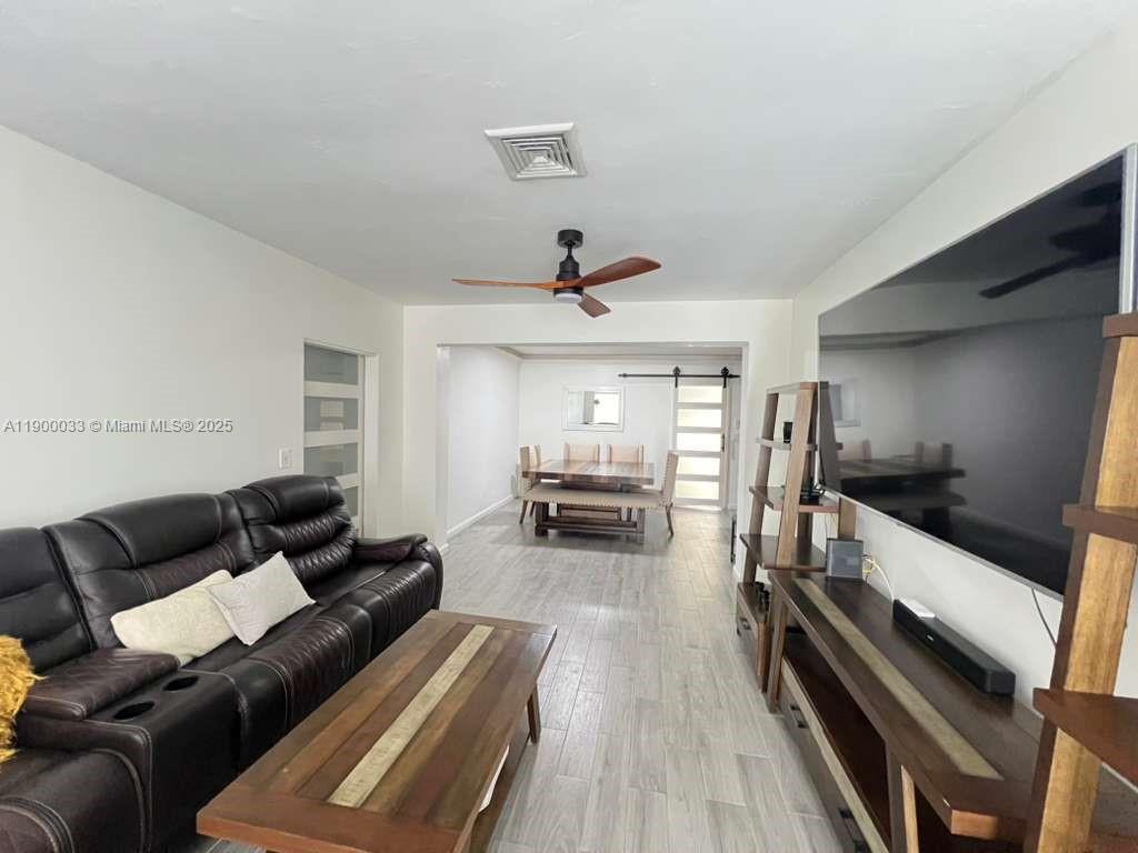 1430 Northeast 149th Street Miami, FL 33161 - Photo 19 of 51 a living room with furniture and a wooden floor
