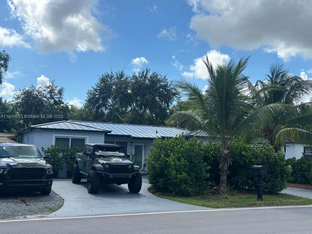 1430 Northeast 149th Street Miami, FL 33161 - Photo 2 of 51 a front view of a house with garden