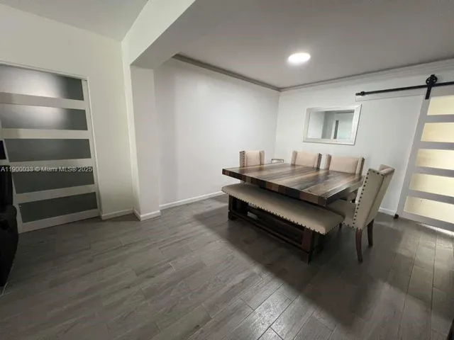 a living room with chairs and a table