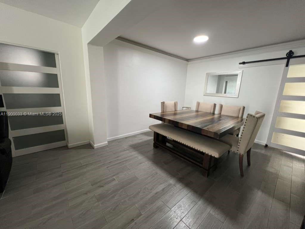 1430 Northeast 149th Street Miami, FL 33161 - Photo 21 of 51 a dining room with furniture and wooden floor