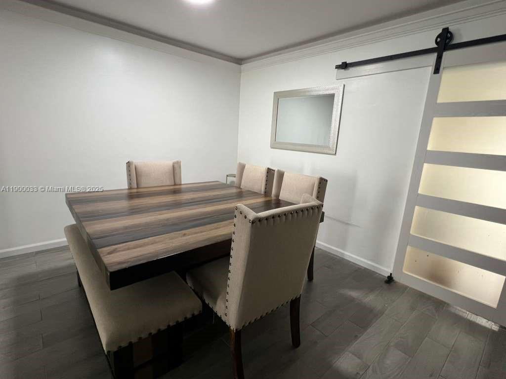 1430 Northeast 149th Street Miami, FL 33161 - Photo 22 of 51 a view of a dining room with furniture and wooden floor