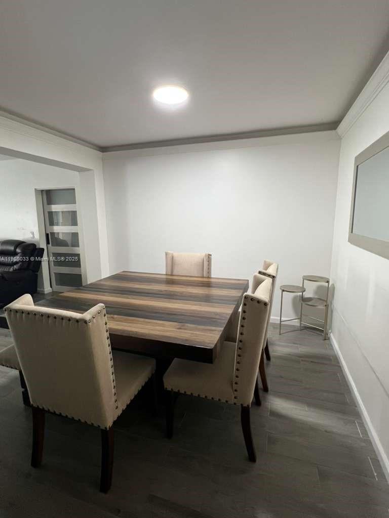 1430 Northeast 149th Street Miami, FL 33161 - Photo 23 of 51 a living room with chairs and a table