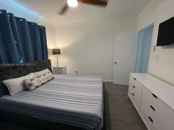 a bedroom with a bed and a flat screen tv