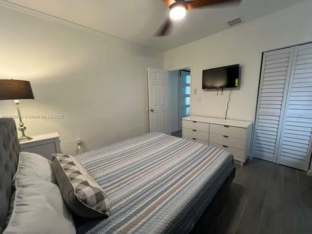 a bedroom with a bed and a mirror