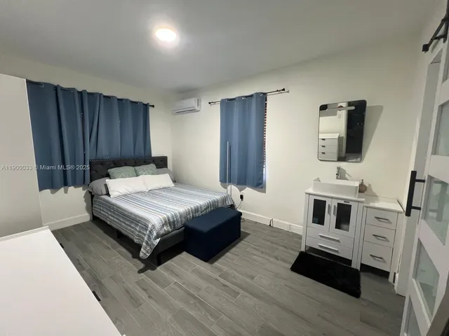 a view of a patio with a table and chairs under an umbrella