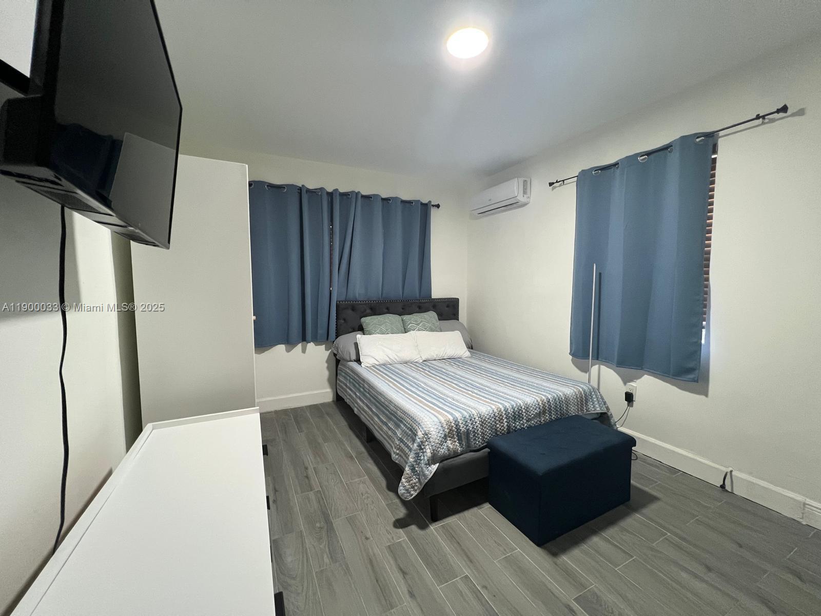 1430 Northeast 149th Street Miami, FL 33161 - Photo 36 of 51 a bedroom with a bed and wooden floor