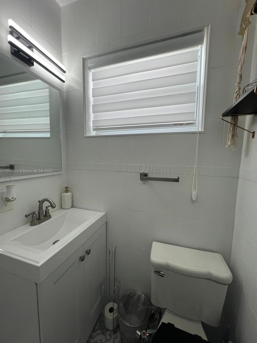 1430 Northeast 149th Street Miami, FL 33161 - Photo 37 of 51 a bathroom with a sink toilet and window