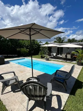 a view of swimming pool with seating space