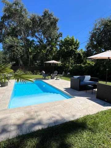a view of swimming pool with seating space