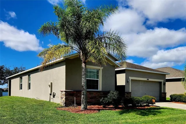 a front view of house with yard and outdoor seating